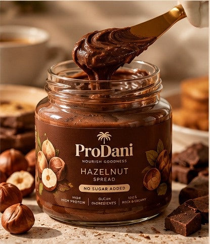 A spoon lifting hazelnut spread from an open ProDani jar
